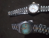 Vendo  relógio  sno 1975 orient automático  e um role femini
